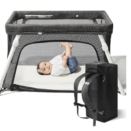 Guava Lotus Travel Crib with baby inside, lightweight portable crib rental with backpack carry case.